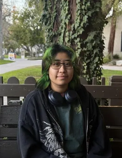 Student Cristy Farfan posing outdoors, representing hands-on automotive training and student success