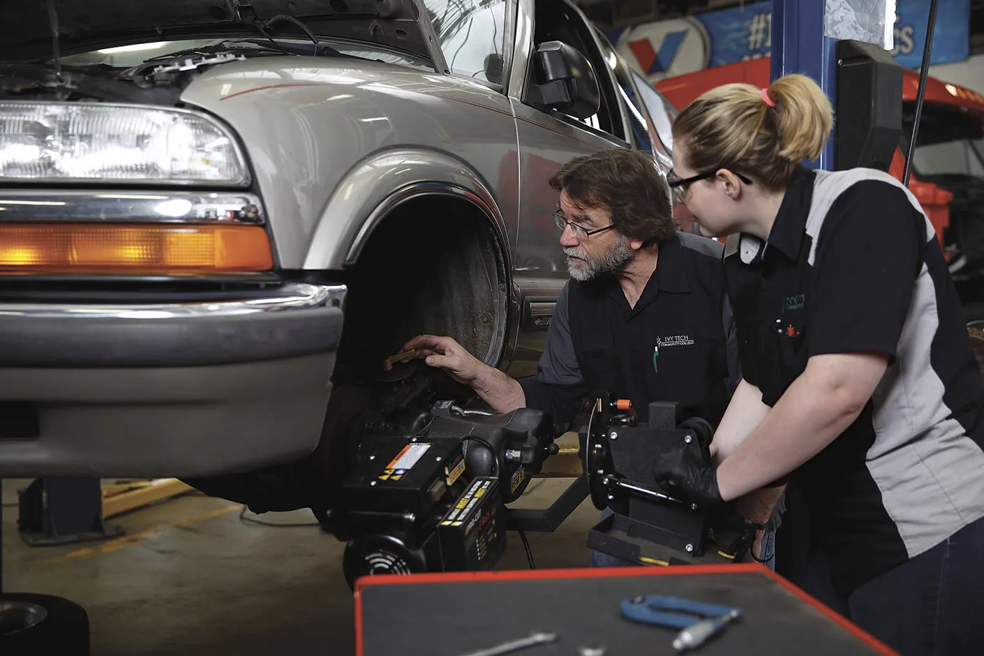 Automotive technology students working on a vehicle