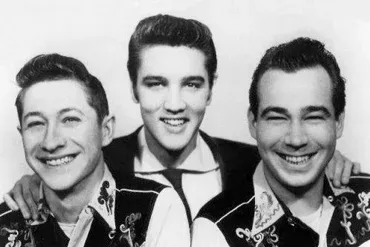The Blue Moon Boys performing live on stage, captivating an audience with their high-energy rock and roll