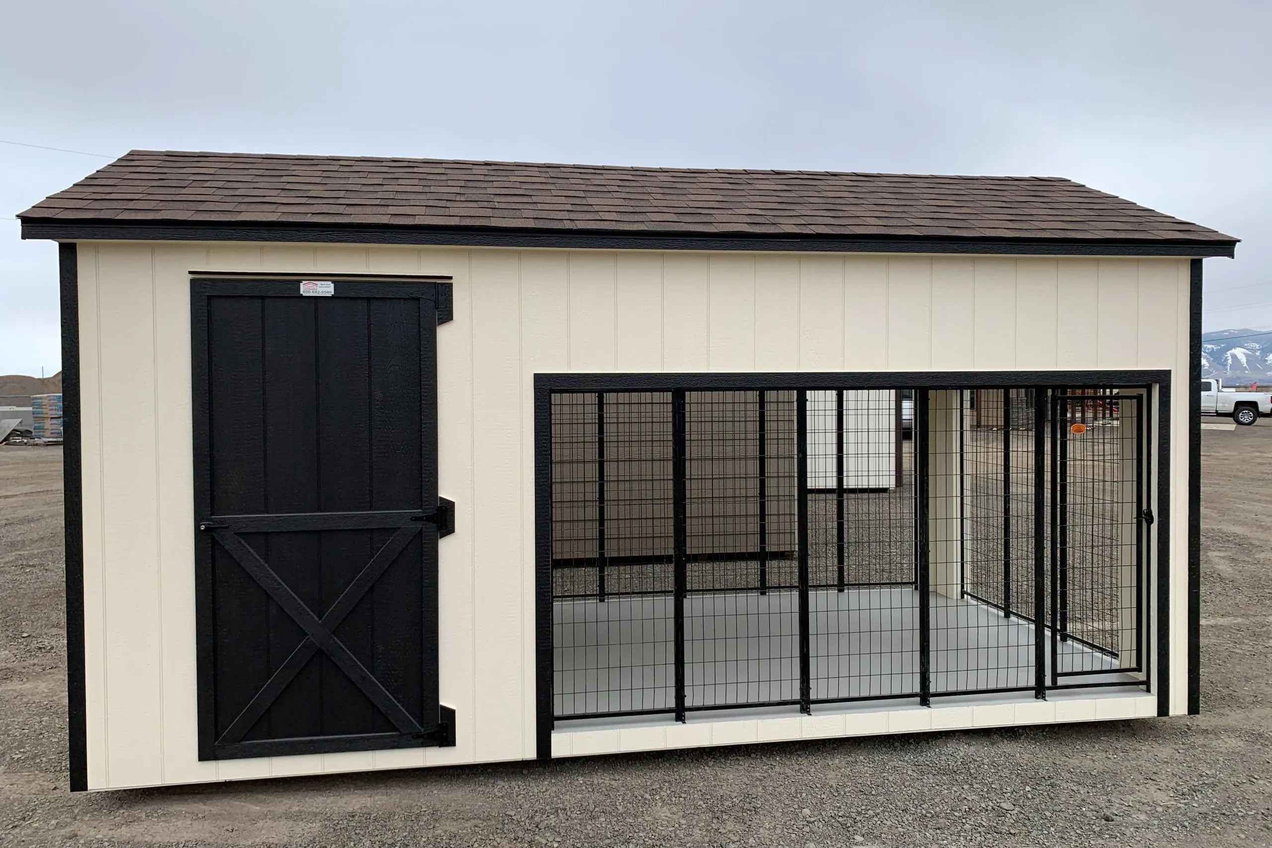 A spacious wooden dog kennel with outdoor run area and sheltered indoor section