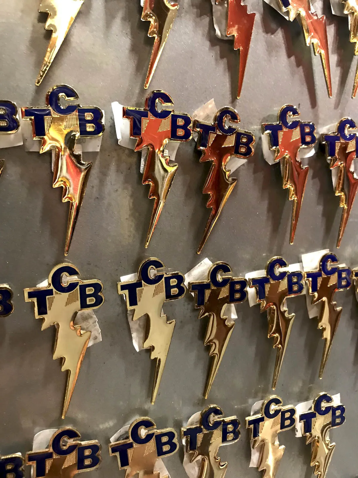 TCB lightning bolt pin badges on display in the Graceland gift shop, Memphis