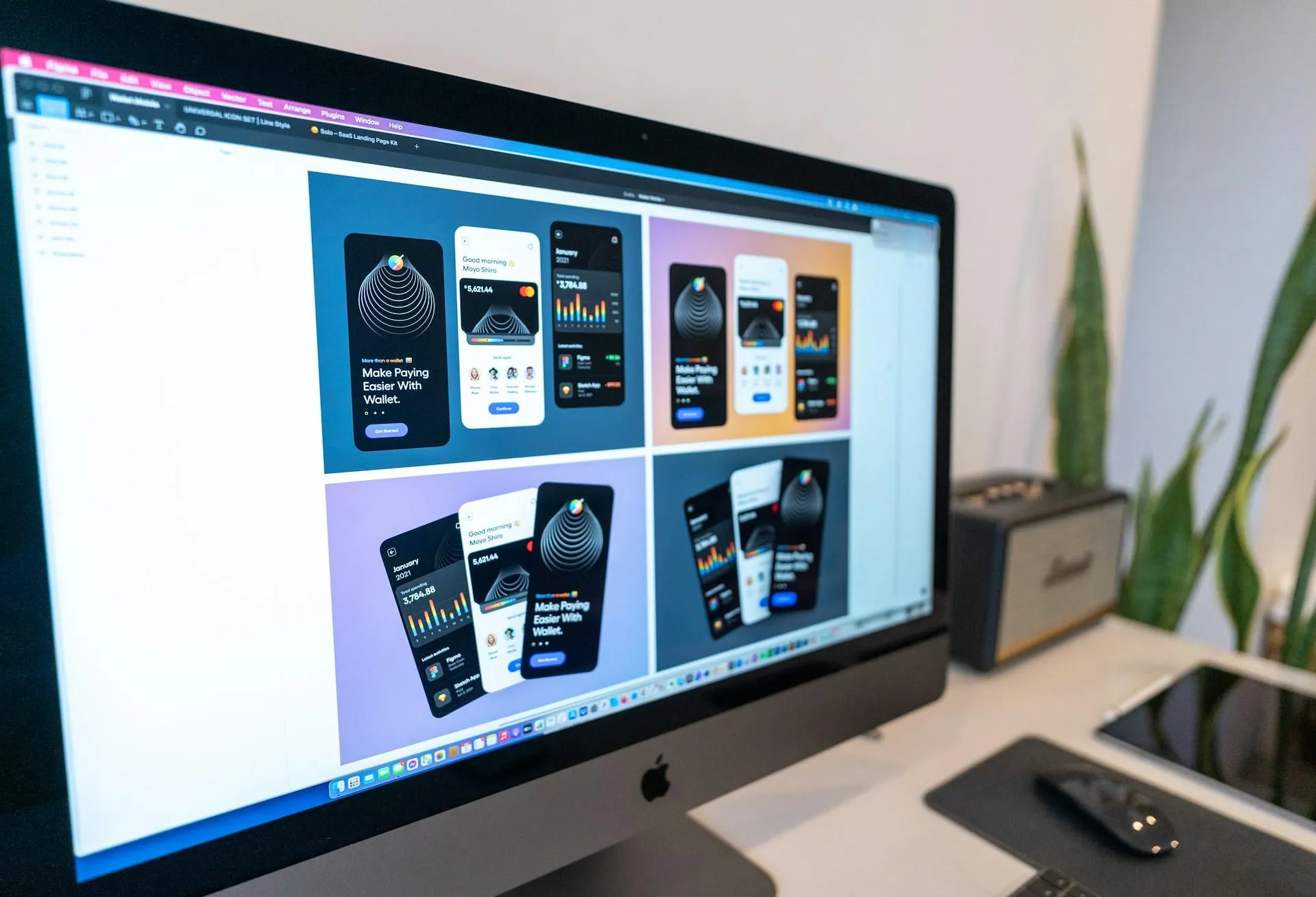 Multiple pages of graphics open in a iMac for Graphic Design.