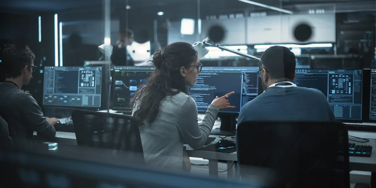 Two Curtin University students in an IT lab, collaborating on software development projects using computers