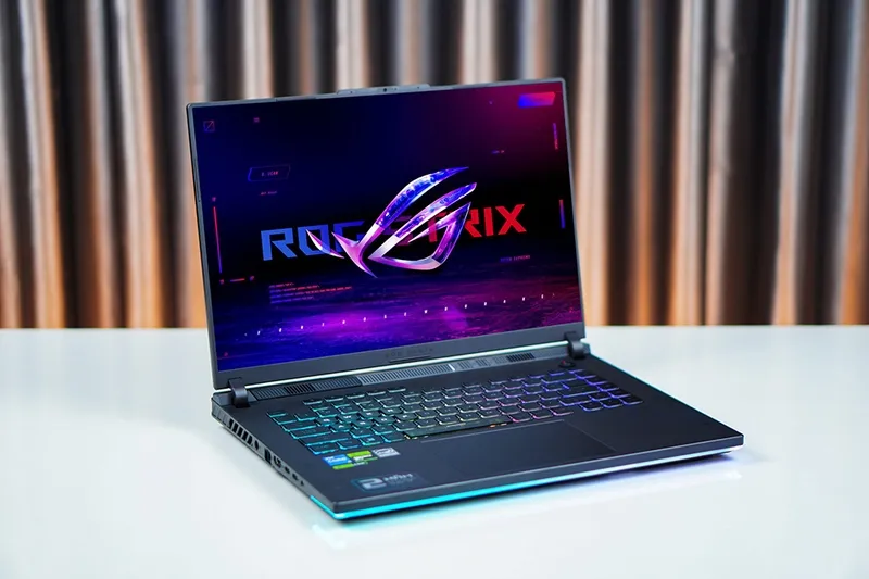 Asus ROG Strix G16 gaming laptop highlighting its RGB lighting, angular design, and robust cooling vents