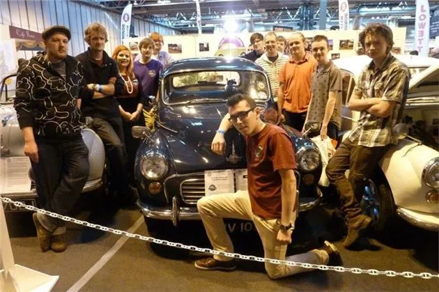 Young classic car enthusiasts gathered at a Morris Minor Owners Club event in the UK