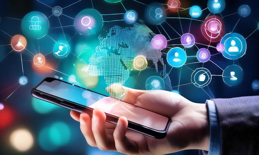 A hand holding a mobile phone with icons zooming out to represent using social media to advertise your business for free