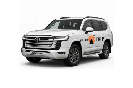 The powerful front grille of a Toyota Land Cruiser, symbolizing its legendary off-road capability and luxury status