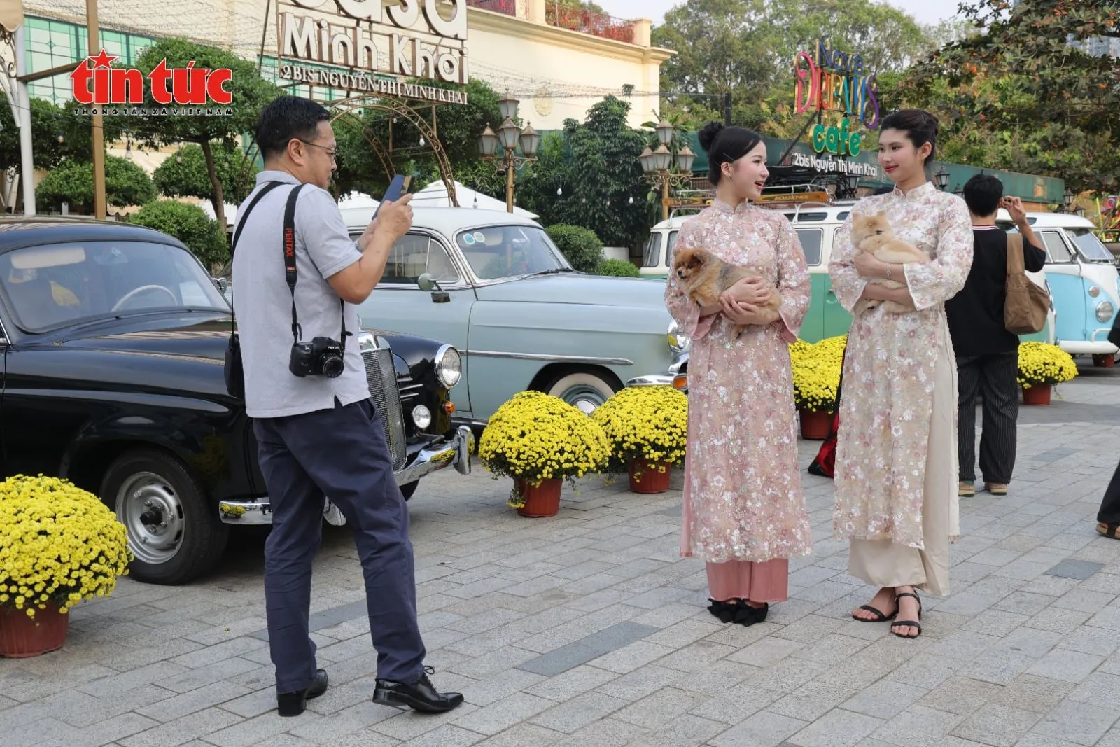 Close-up of young visitors capturing photos with vintage cars