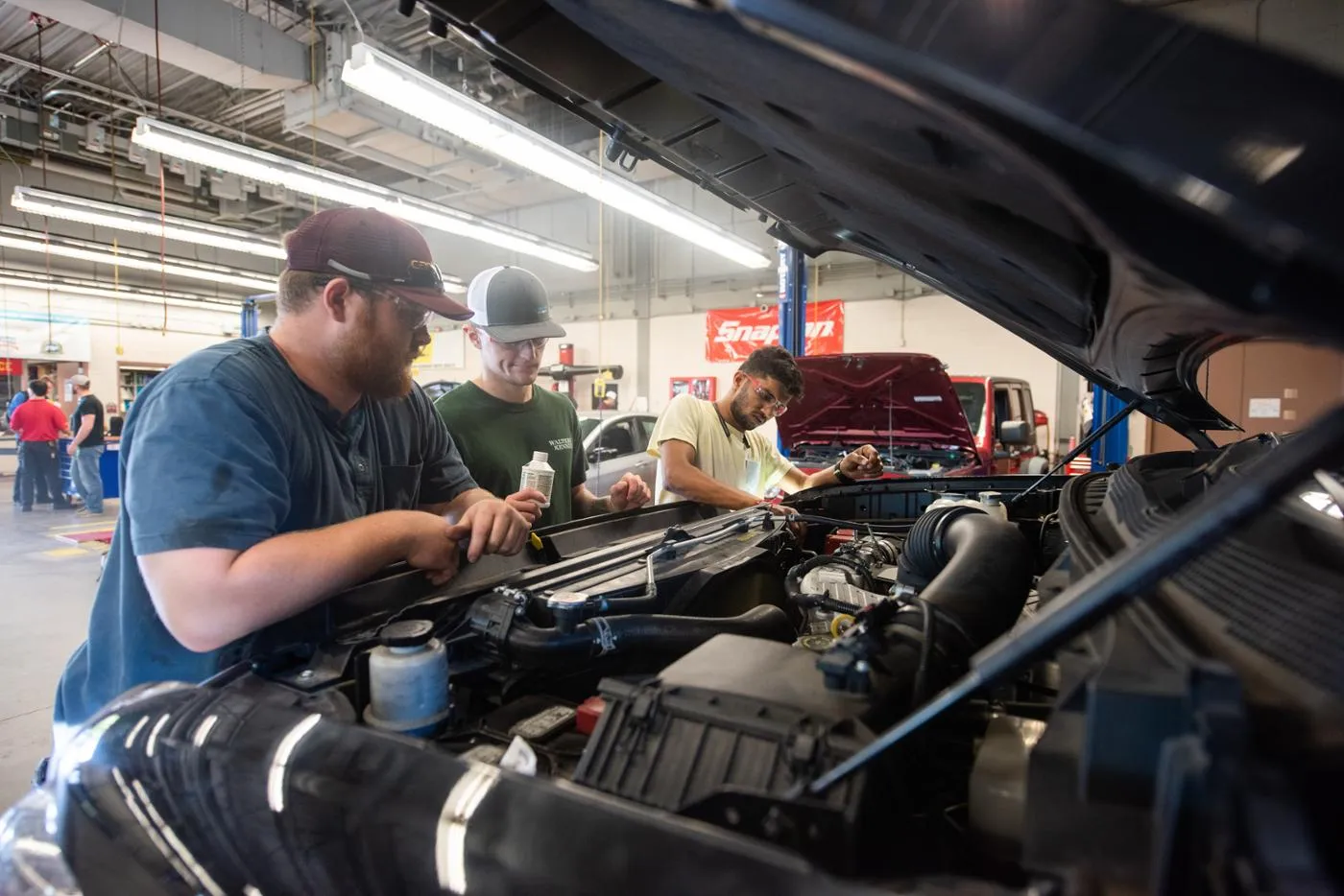 Student and professor diagnosing a vehicle in an automotive technology training environment