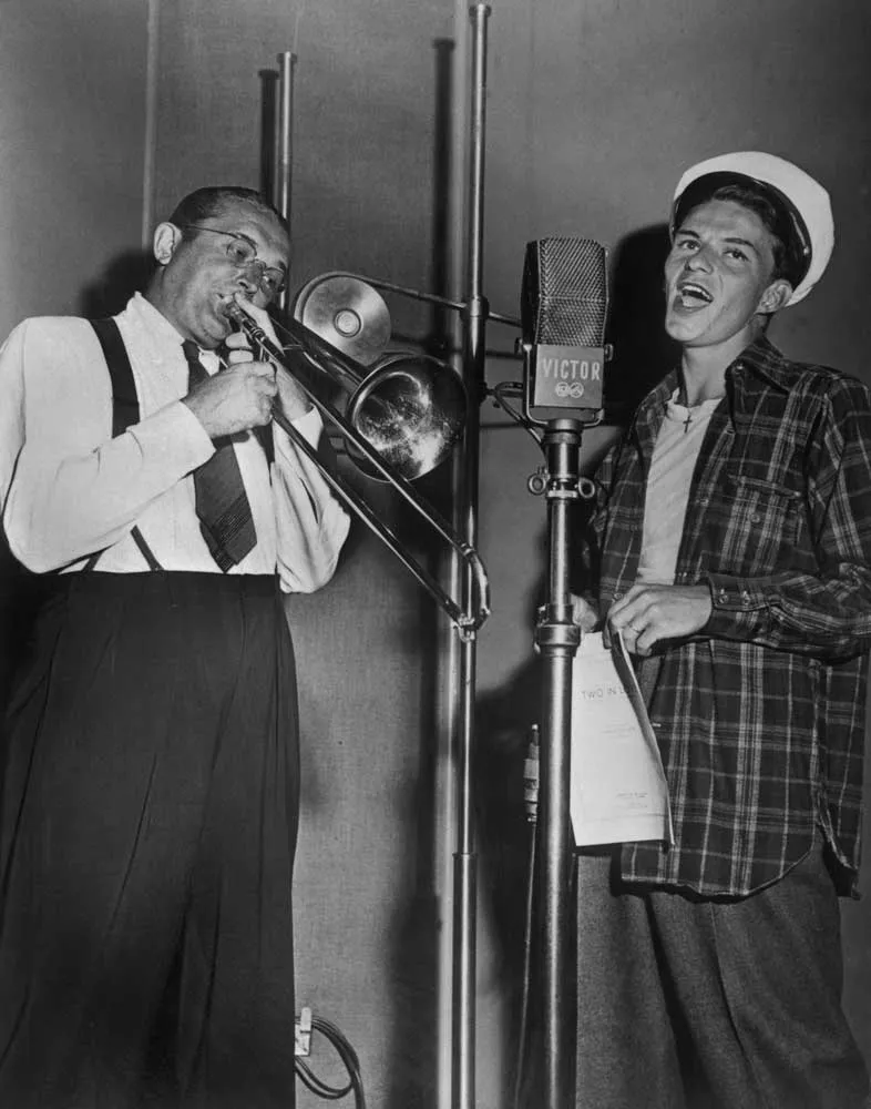 Tommy Dorsey, American trombone, trumpet and clarinet player, composer, arranger and band leader, with Frank Sinatra during a recording session at RCA Victor Studios, New York City, 1941