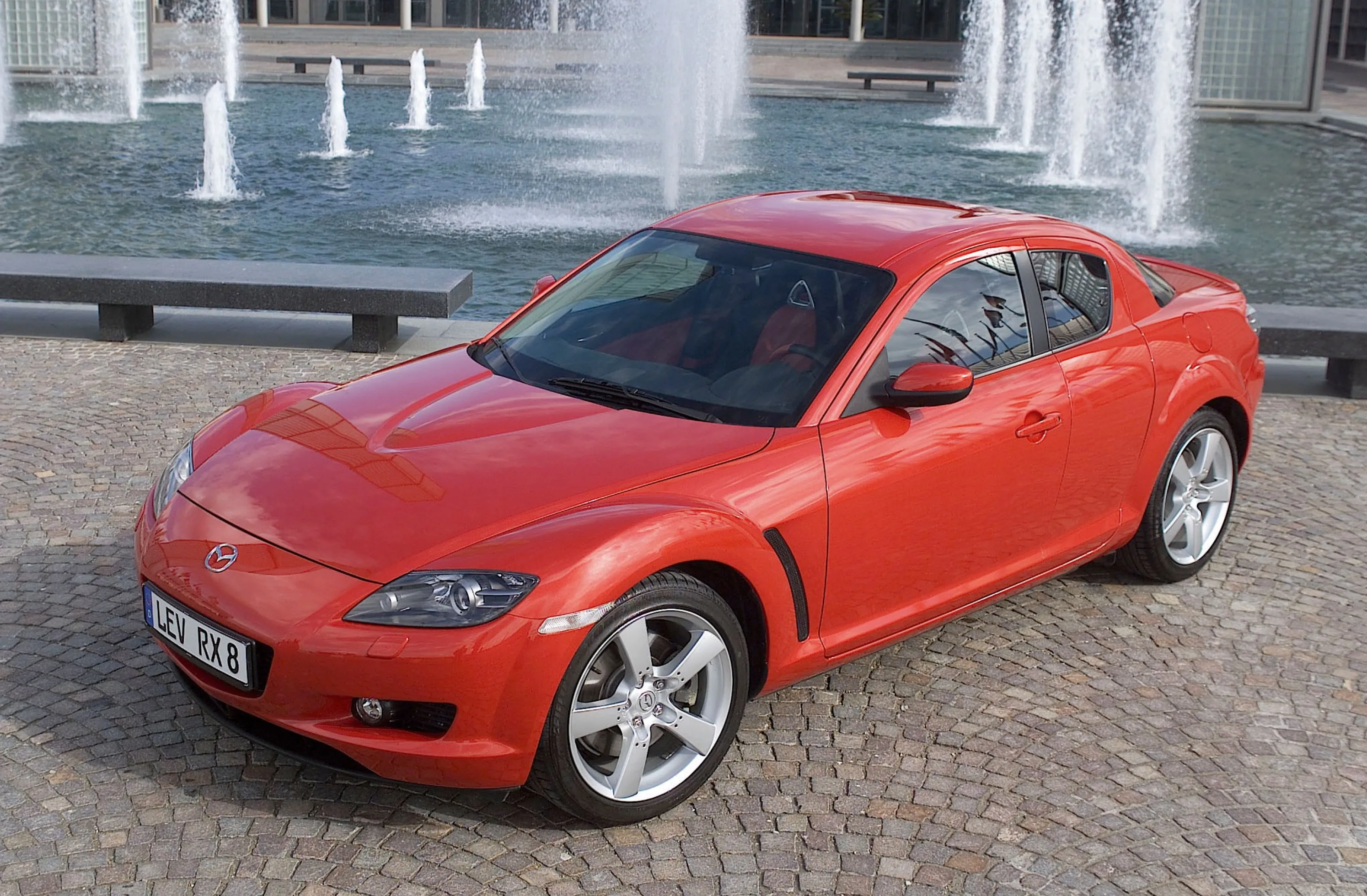 Mazda RX-8 in motion on a winding road