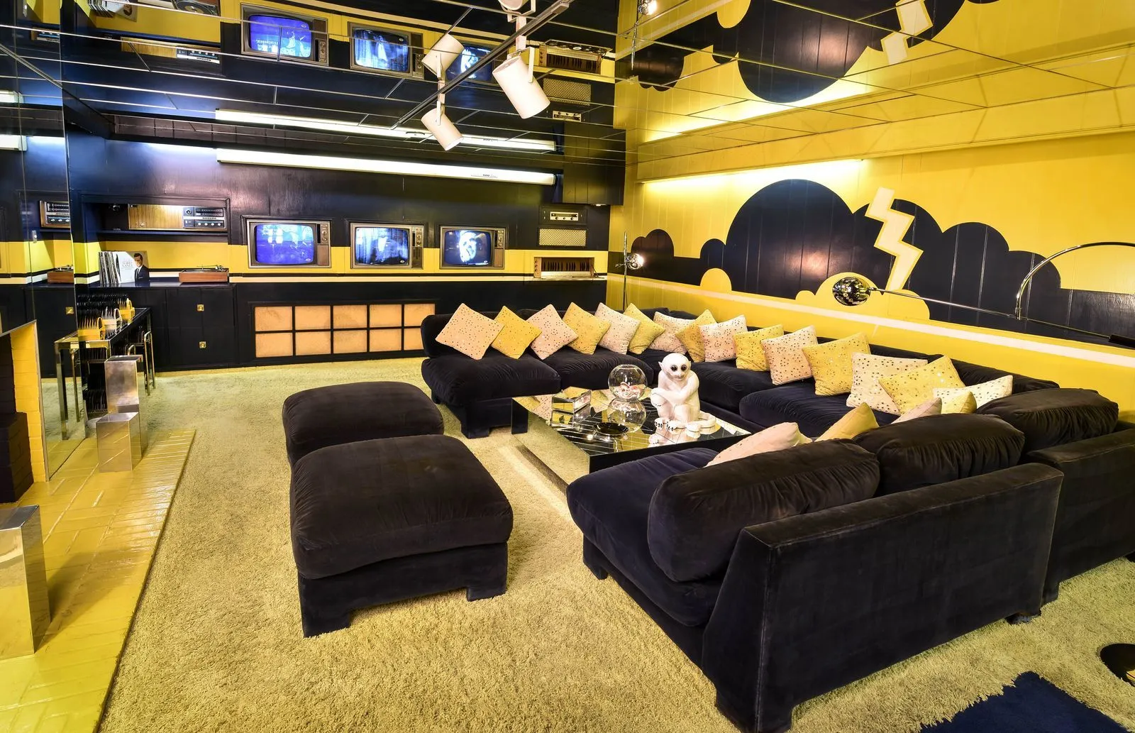 Graceland TV room with mirrored walls and three television screens