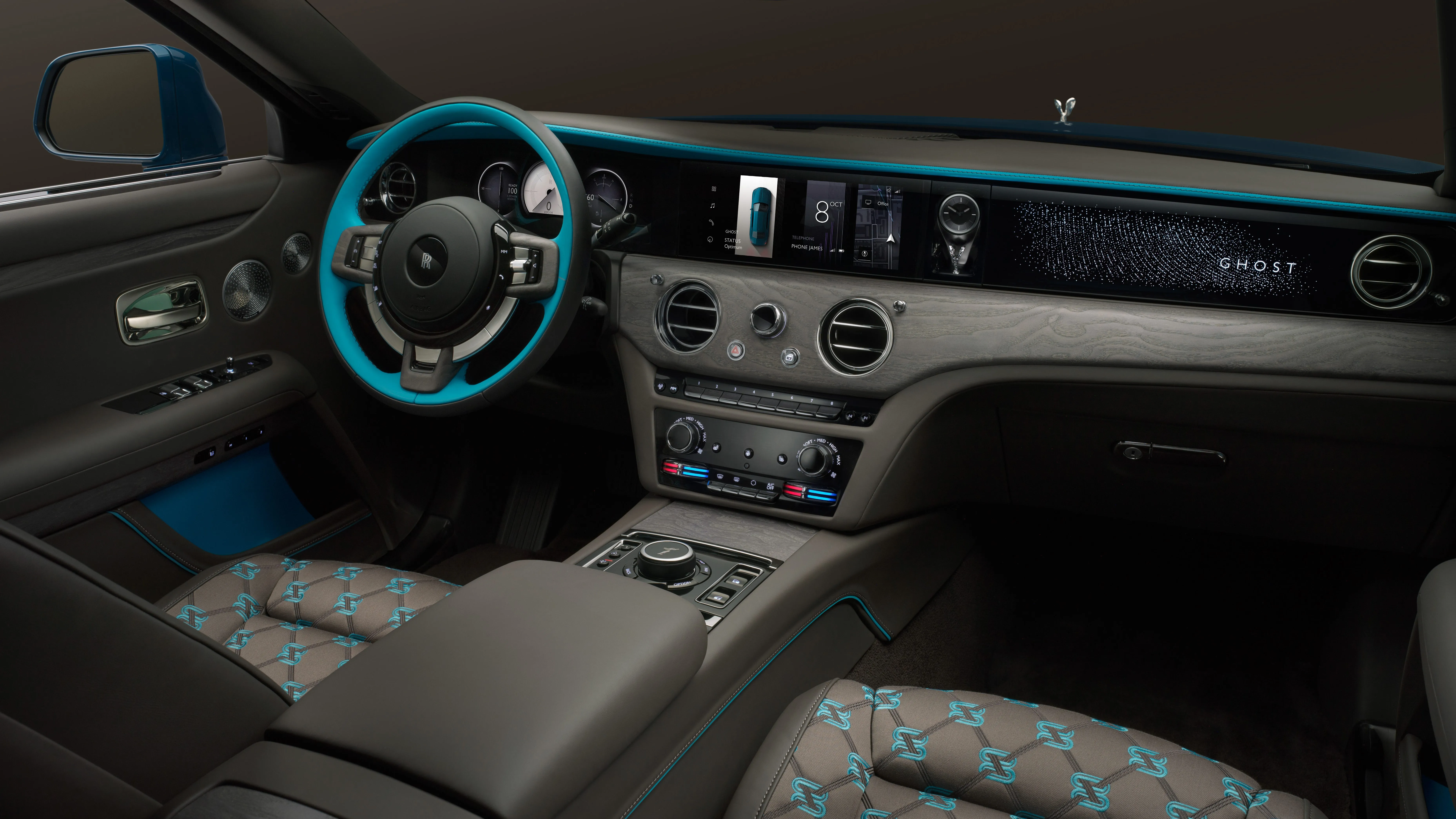 Handcrafted Rolls-Royce Ghost interior featuring illuminated dashboard trim and luxury seating
