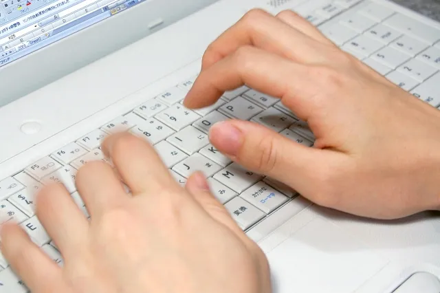 Person using a keyboard to manage spreadsheet settings in Microsoft Excel