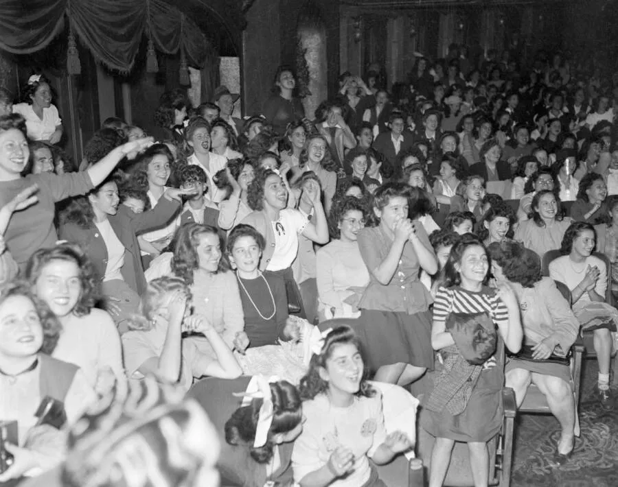 Young Frank Sinatra performing before ecstatic fans during the height of Sinatramania