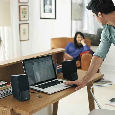 Compact PC desktop speaker setup with subwoofer on a clean desk