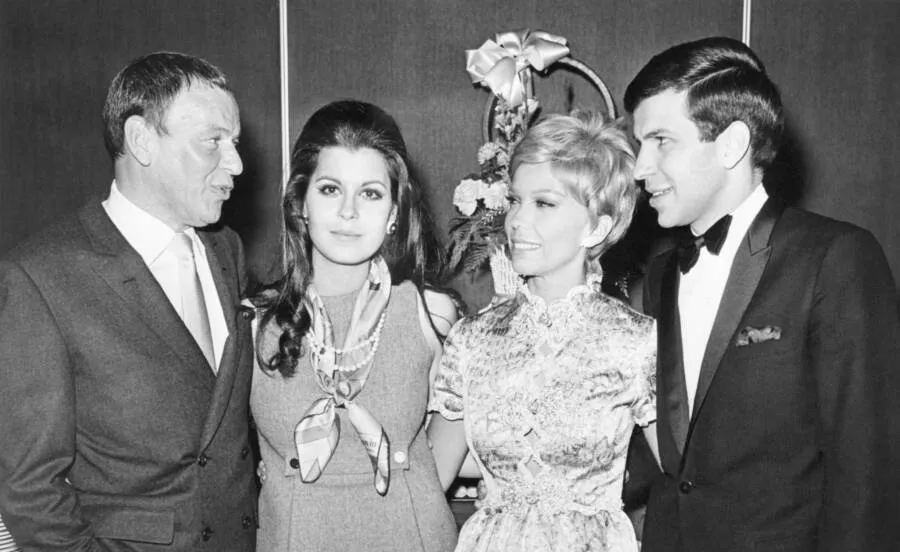 Frank Sinatra posing with his children Nancy, Tina, and Frank Sinatra Jr. in Las Vegas