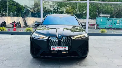 BMW iX electric luxury SUV displayed in a premium showroom