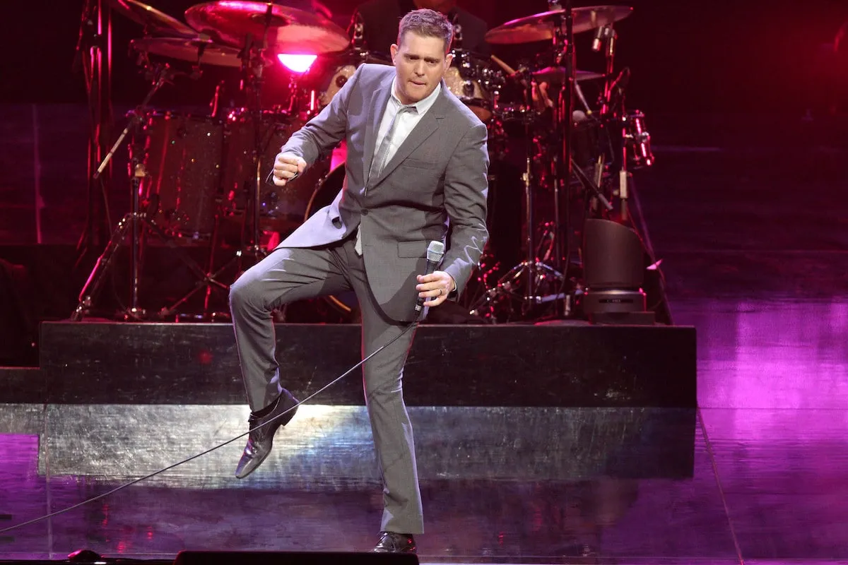 Michael Bublé performing live on stage with a classic microphone