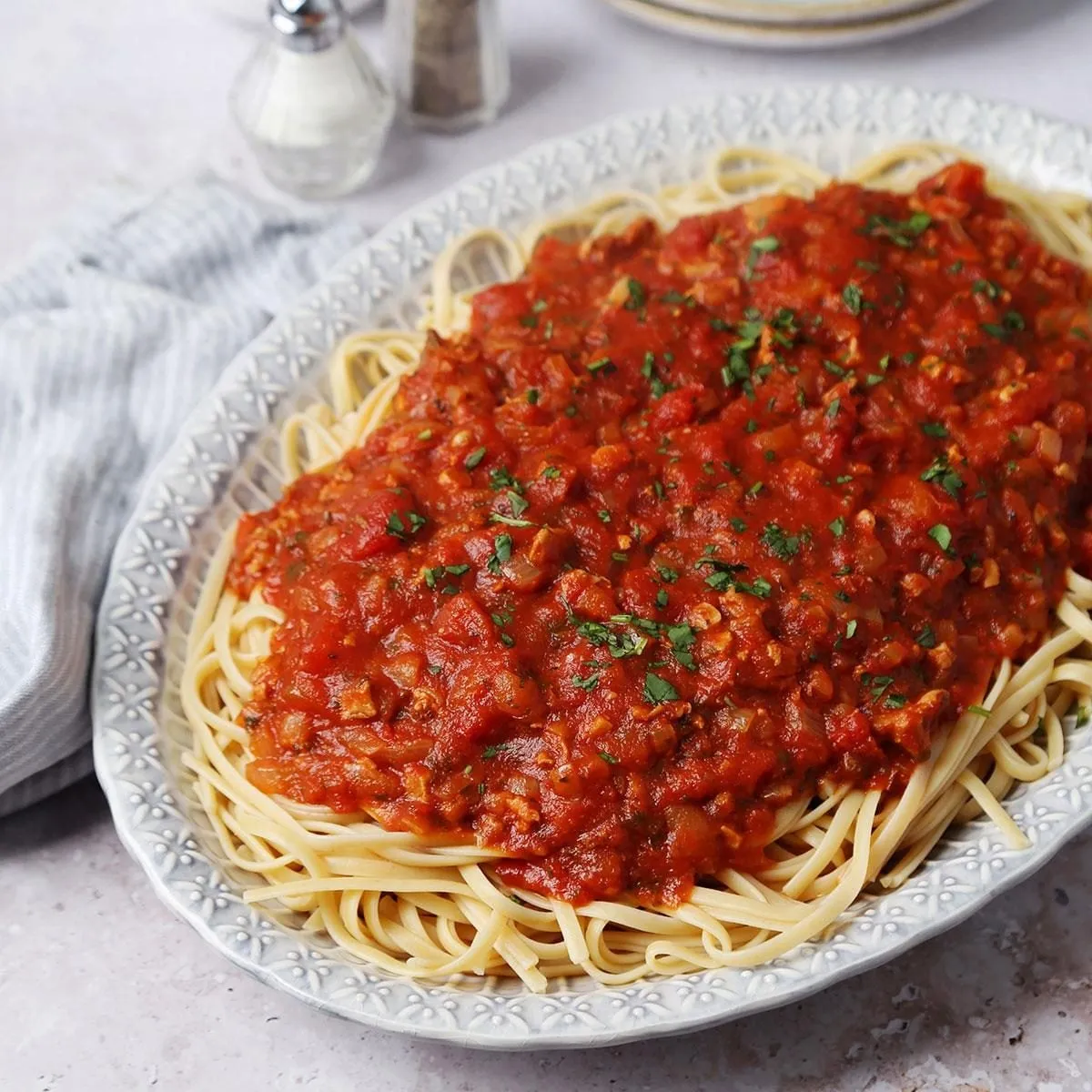 Clams in red tomato-basil sauce served over linguine
