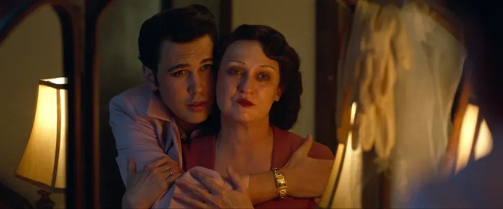 Austin Butler and Olivia DeJonge portraying Elvis and Priscilla Presley in a stylized intimate film scene reflecting 1960s fashion aesthetics