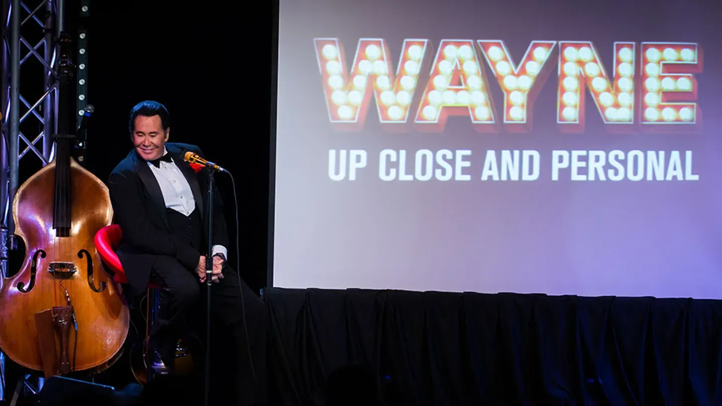 Wayne Newton on stage, delivering a performance that has defined his career