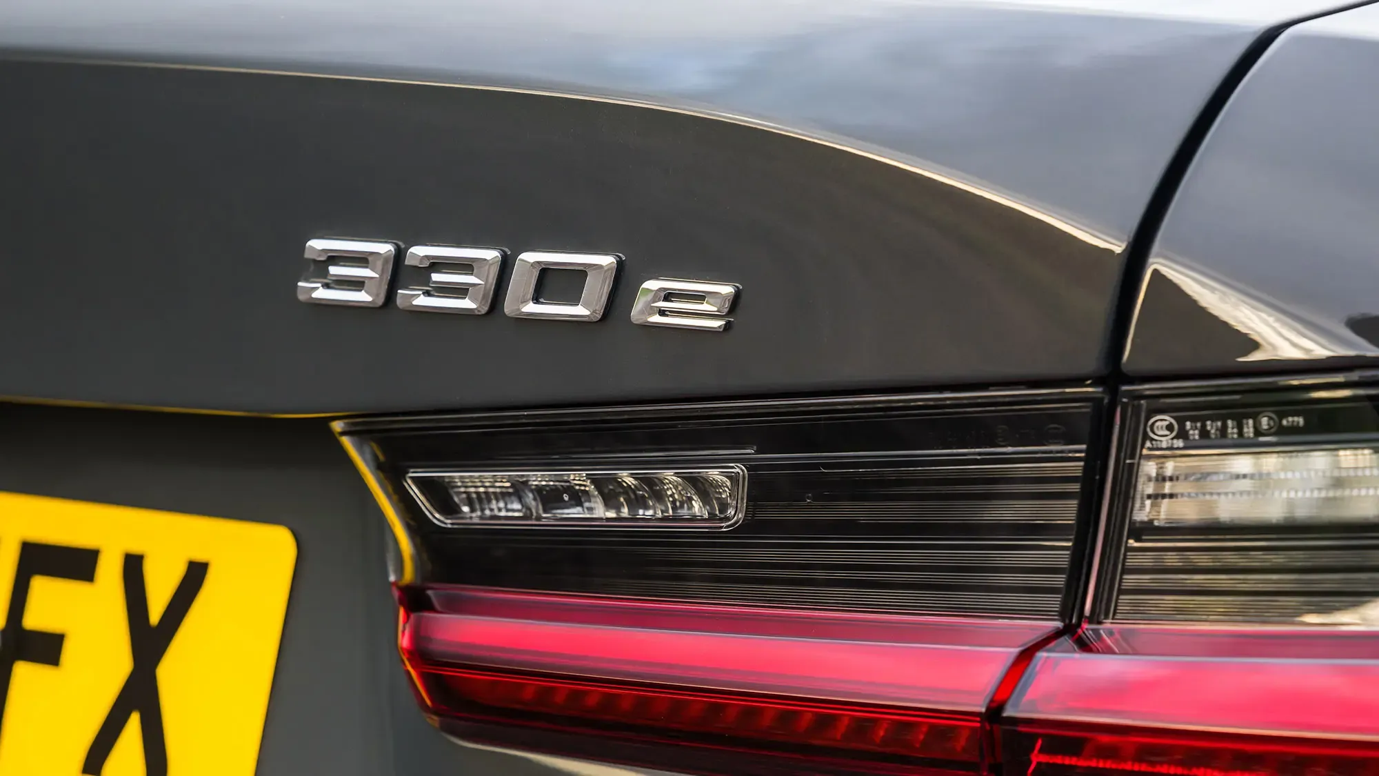 BMW 330e (2024) rear badge detail in grey paint showing the 330e designation