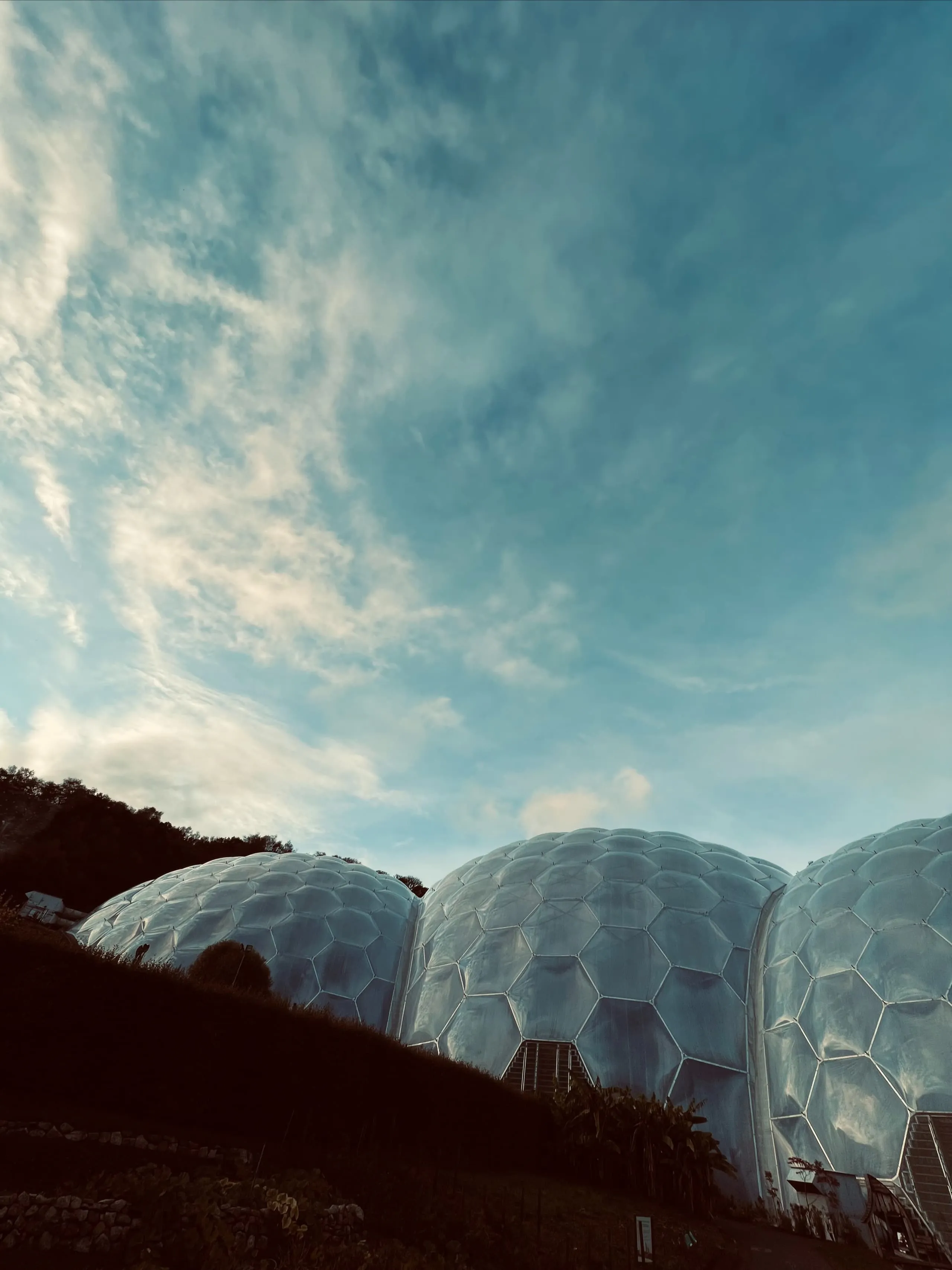 3 connected greenhouse biospheres representing environmental sustainability