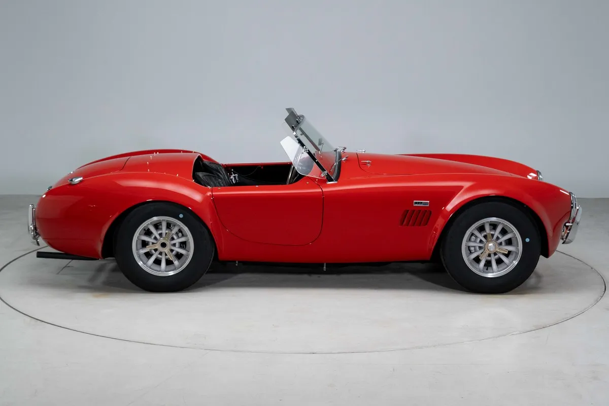 Front three-quarter view of a restored 1966 Shelby 427 Cobra in factory-correct red finish