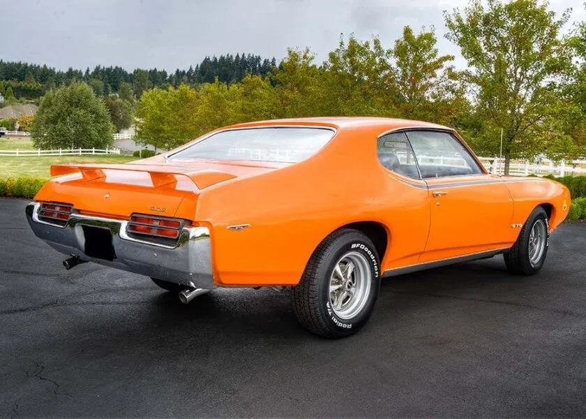 Rear three-quarter view of a 1969 GTO Judge showcasing the spoiler and stripe package