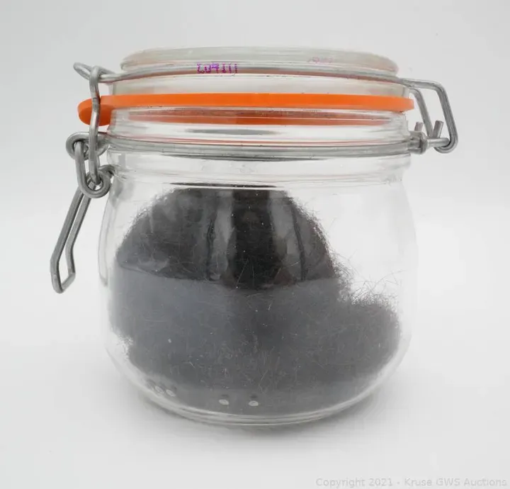 Jar containing a ball of Elvis Presley's hair