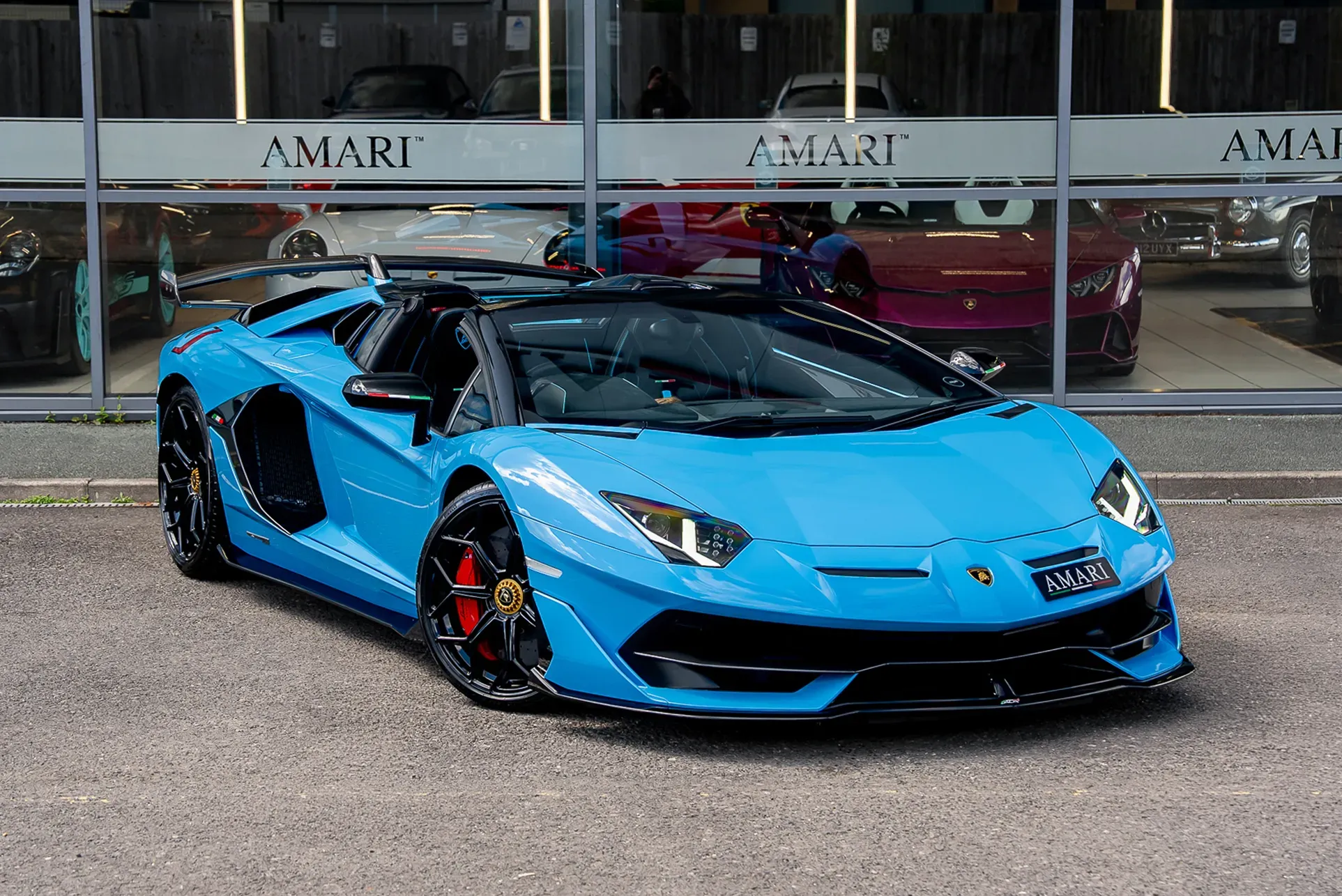 2021 Lamborghini Aventador SVJ Roadster in Blue Cepheus parked under studio lighting