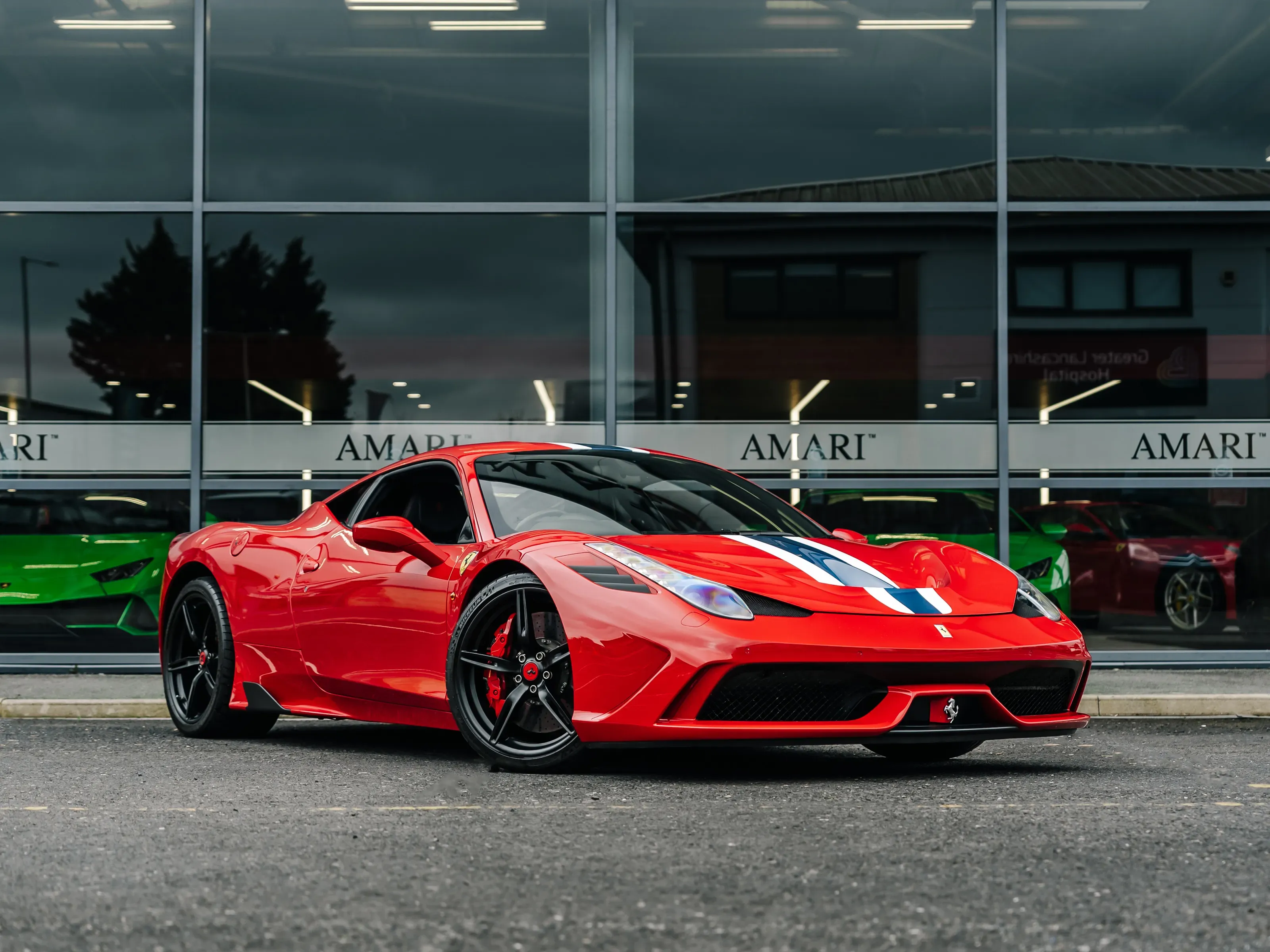 2014 Ferrari 458 Speciale in Rosso Corsa displayed in showroom lighting