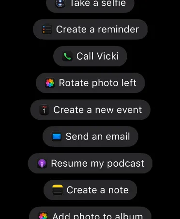Screen with requests for Siri AI to take action in apps, including Take a selfie, Create a reminder, Call Vicki, and more.