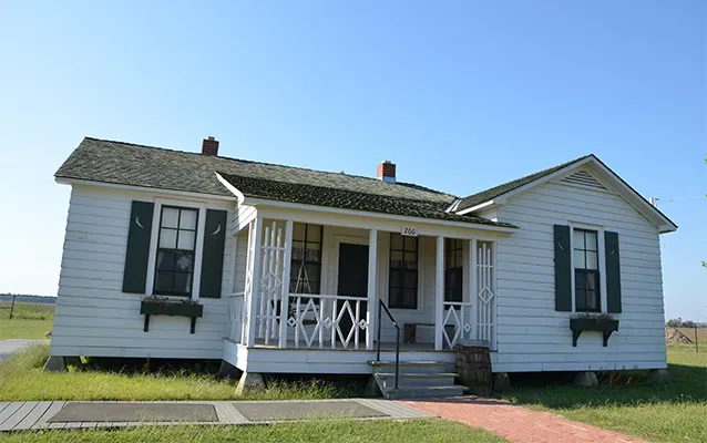 Five-room white farmhouse with covered porch where Johnny Cash grew up in Dyess, Arkansas