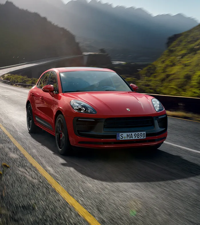 Porsche Macan compact SUV driving in dynamic urban environment