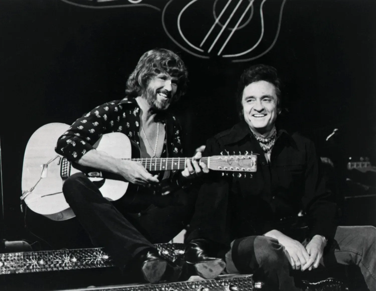 Kris Kristofferson and Johnny Cash performing together on stage during a 1976 television appearance