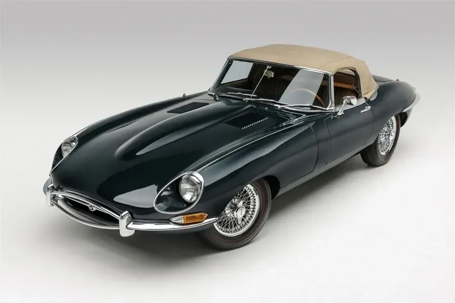 Jaguar E-Type Roadster Series 1.5 showing deep green exterior paint and polished 15-inch wheels with red-stripe tires