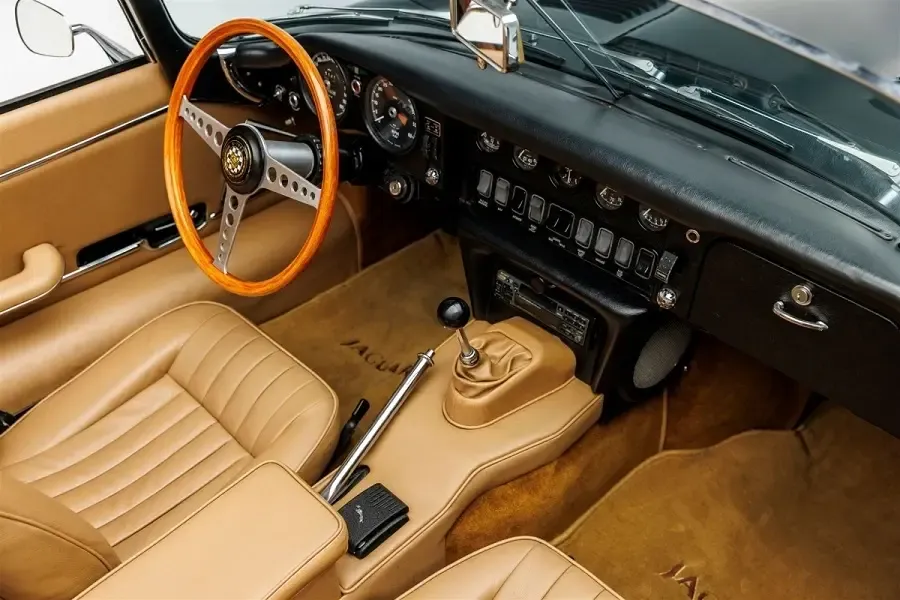 Jaguar E-Type Series 1.5 Roadster interior showing tan leather seats and analog instrumentation dashboard