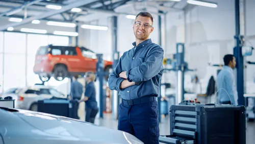 automotive technician performing quality control inspection on vehicle
