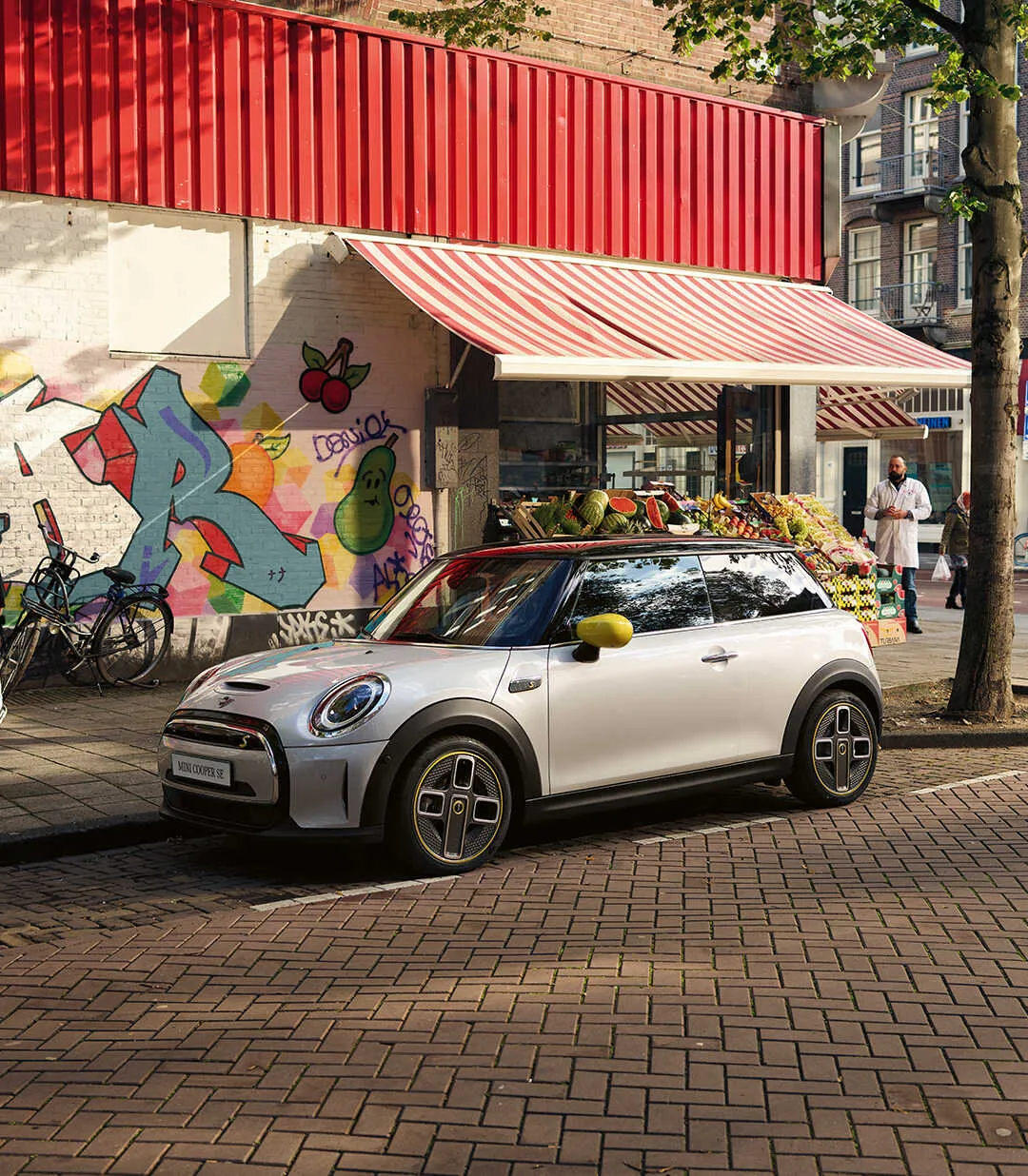 Exterior view of the 2025 MINI Cooper Electric in a city setting