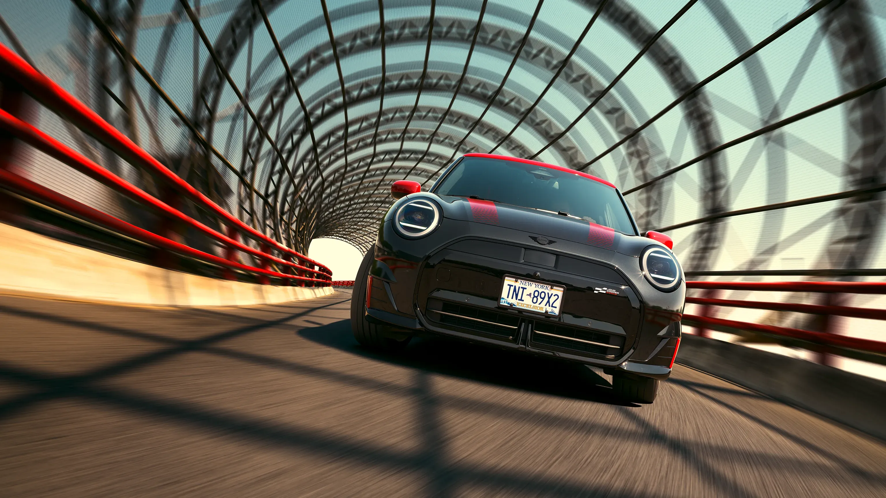 MINI John Cooper Works Pack in dynamic driving stance emphasizing sport performance