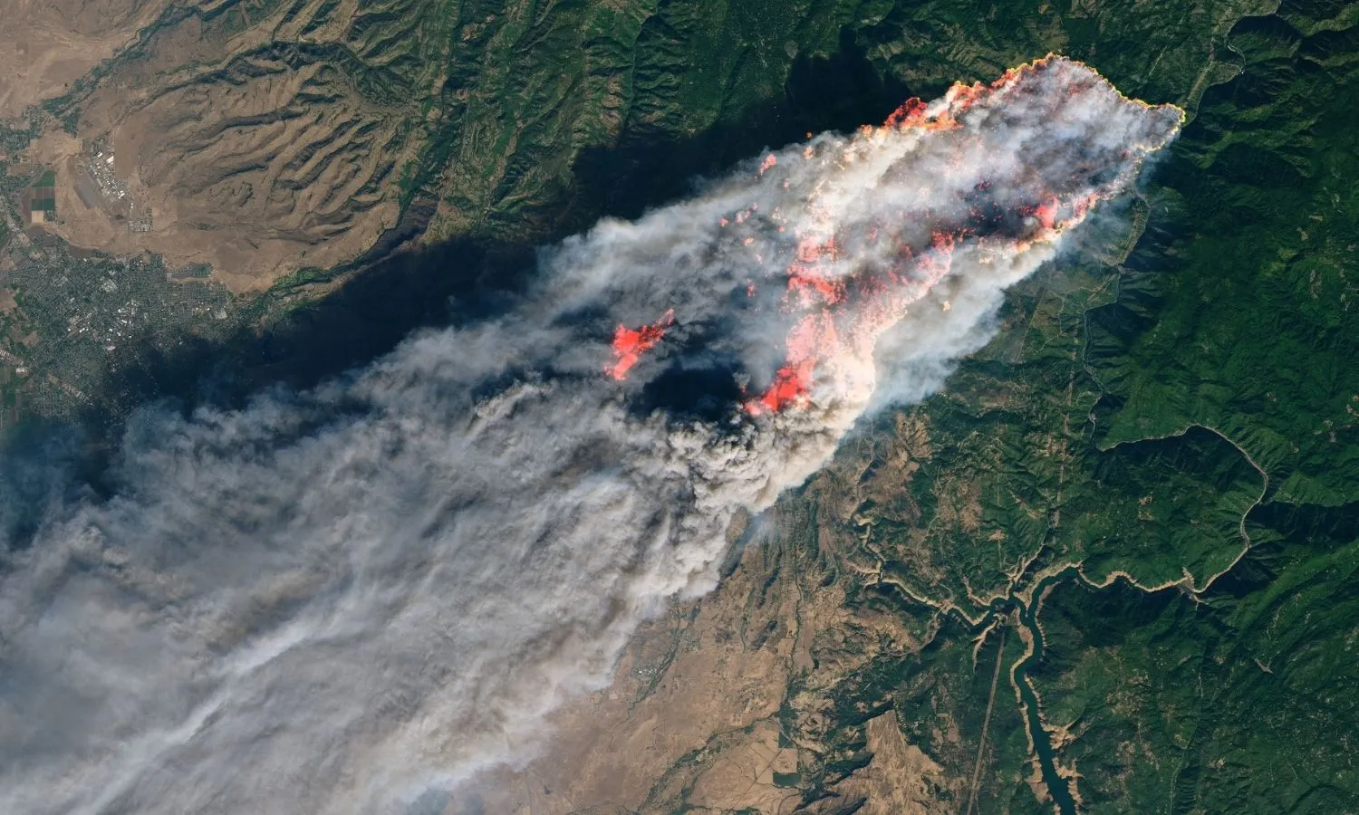 Wildfire smoke and destruction spread across forest regions during the 2018 California Camp Fire