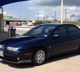 A well-maintained 1998 Saturn SL2 with original deep blue paint, representing a survivor car with documented service history