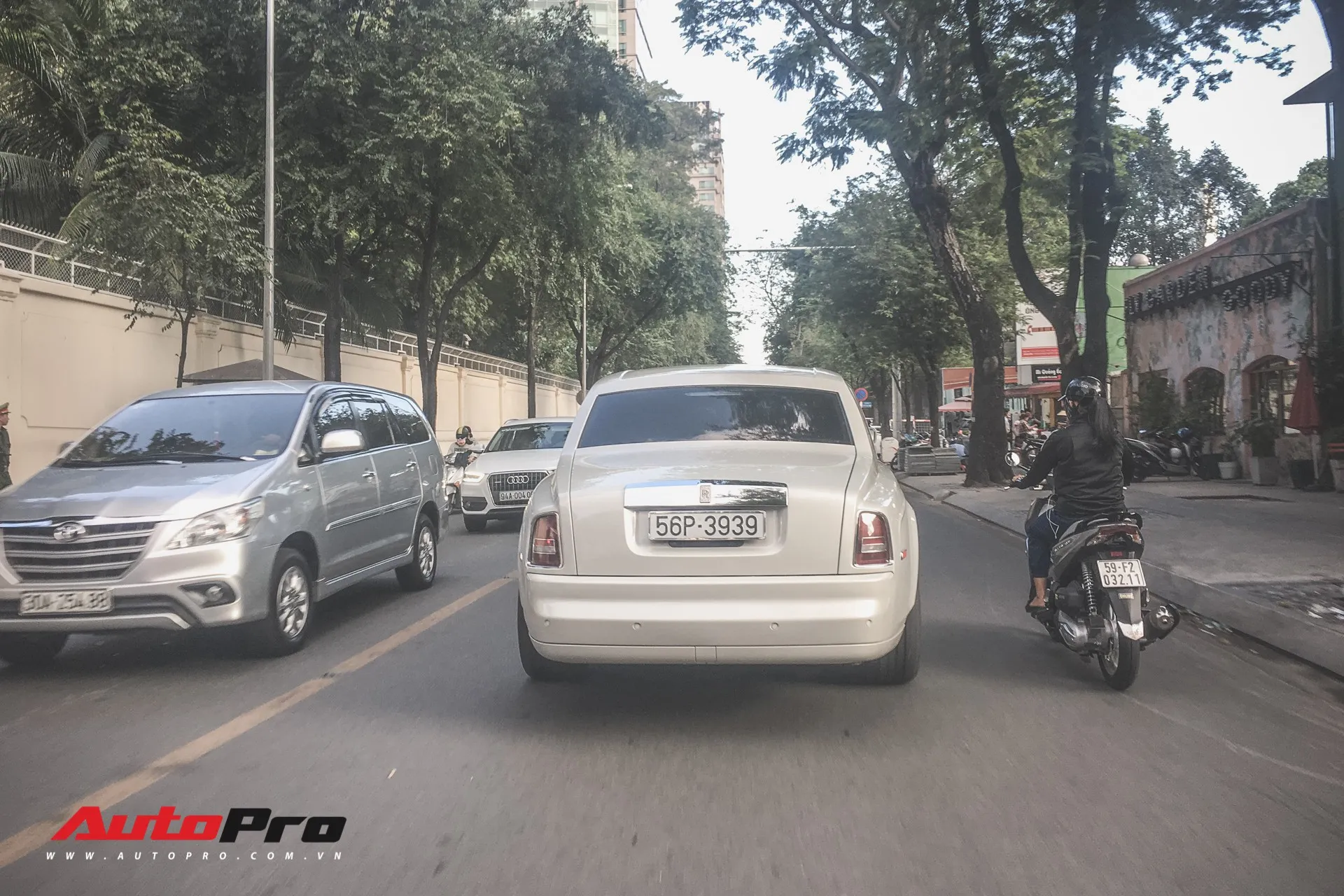 White Rolls-Royce Phantom Series I driving through downtown Ho Chi Minh City