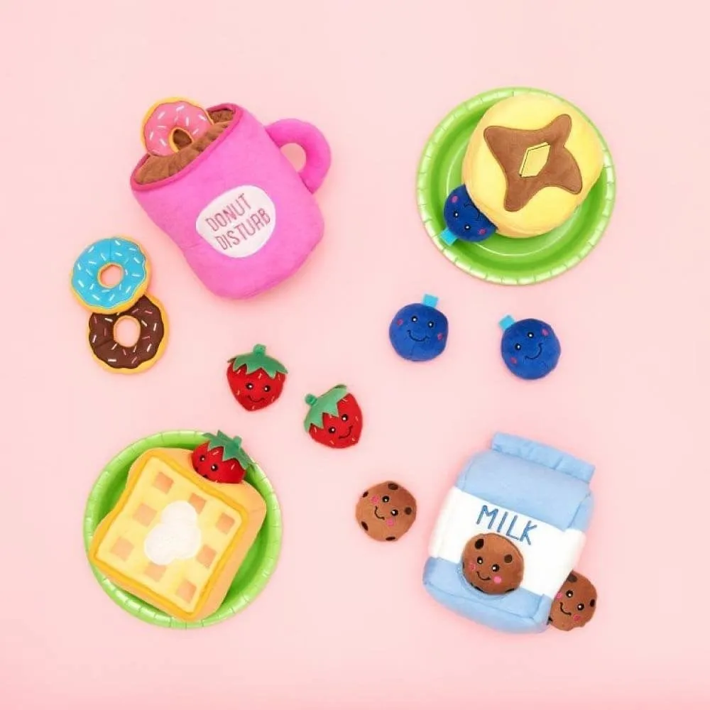 Assortment of the dog toys, including a milk carton, waffle, pancake, and donut in a mug