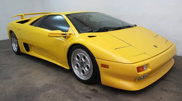Classic 1990s supercar lineup featuring McLaren F1 competitors at a historic automotive event