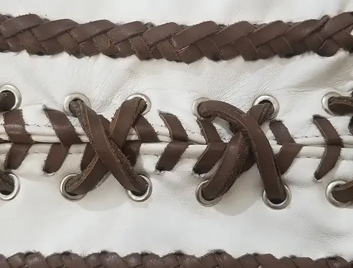Detailed close-up of the stitching and leather craftsmanship on an Elvis 1968 Comeback suit replica