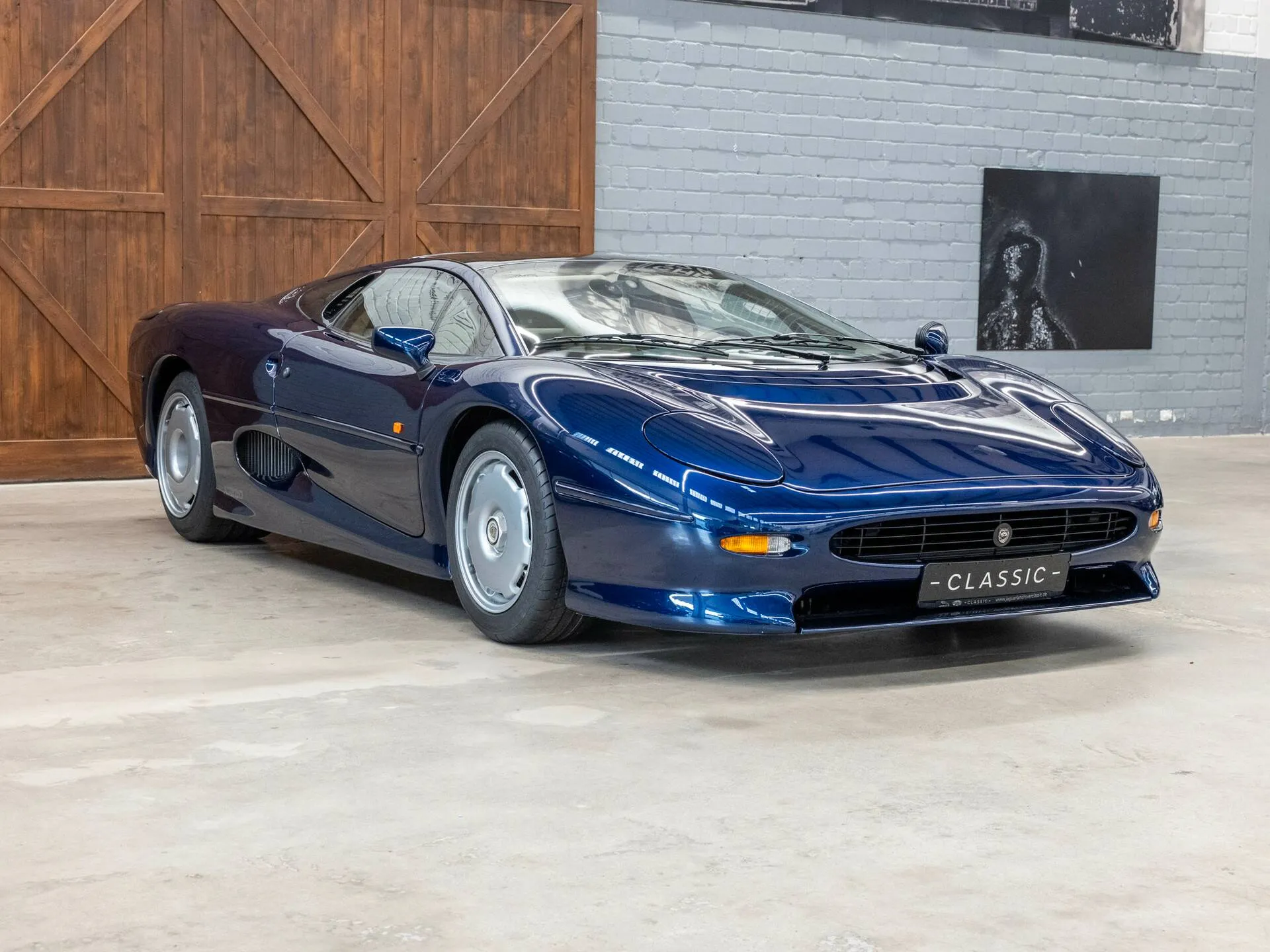 Jaguar XJ220 displayed in dealership listing with clean exterior presentation and auction-quality condition