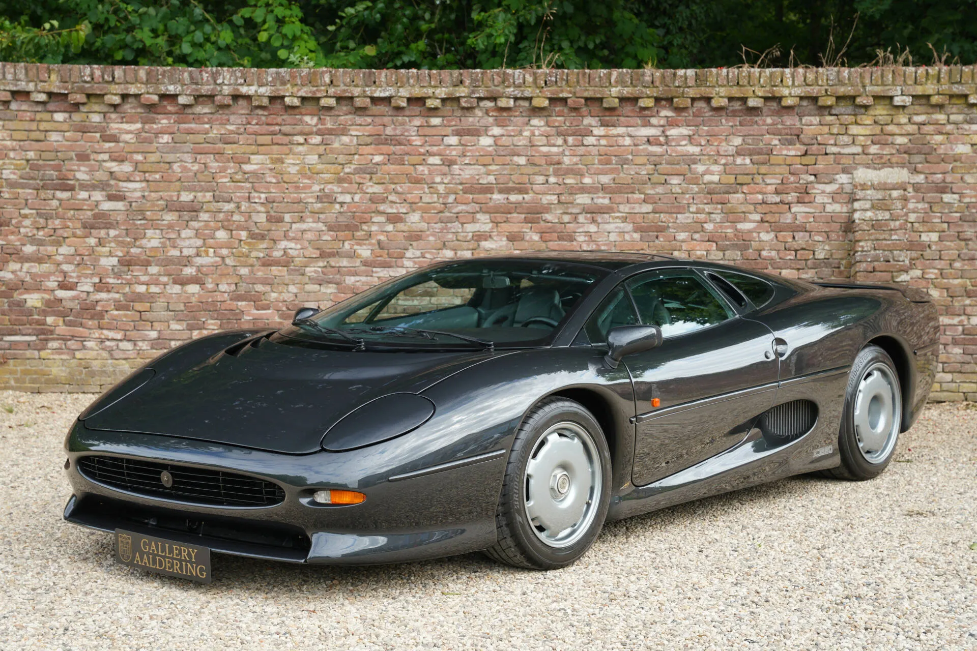 Interior view of Jaguar XJ220 showing driver-focused cockpit and leather seating